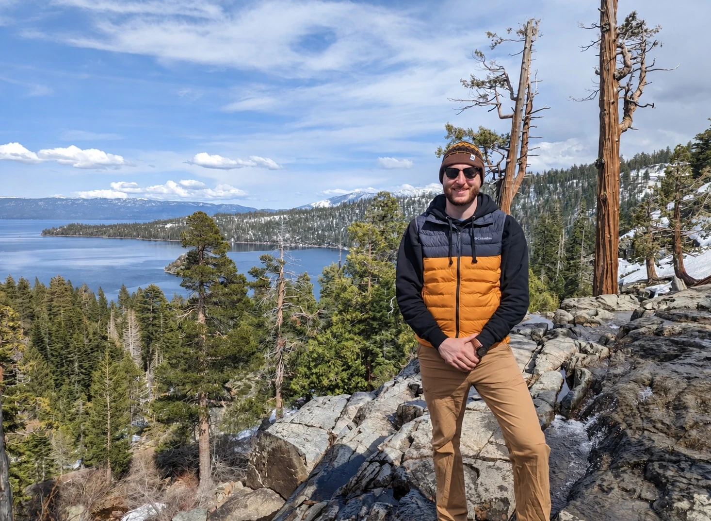 The founder of Three Rivers Genealogical Services standing beside a mountain lake